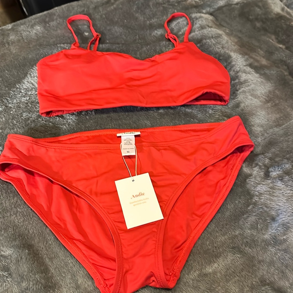 Andie women’s bikini in red. Top size small bottoms, size medium never worn.NWT